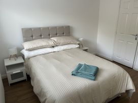 A bedroom with a bed and nightstand at 40 Gloddaeth View in Penrhyn Bay