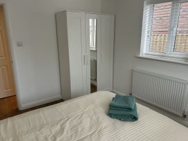 A bedroom with a bed and wardrobe at 40 Gloddaeth View Penrhyn Bay
