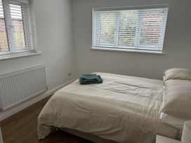A bedroom with a bed and towels at 40 Gloddaeth View in Penrhyn Bay
