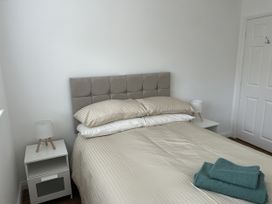 A bedroom with a bed and bedside tables at 40 Gloddaeth View Penrhyn Bay