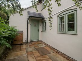 An outdoor area with a green door and windows at 2 Loxter Villas Wellington Heath near Ledbury