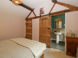 A bedroom with a bed and an attached bathroom at 2 Loxter Villas Wellington Heath near Ledbury
