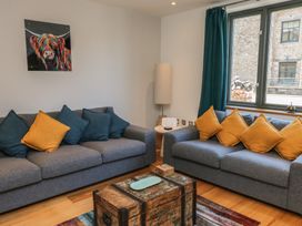 A living room with sofas and a coffee table at 8 Pottery Cottages