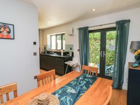 A dining room with a wooden table and chairs at 8 Pottery Cottages 