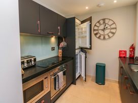 A kitchen with modern appliances at 8 Pottery Cottages