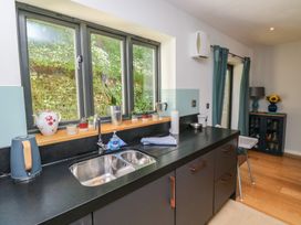 A kitchen with a sink and cabinets at 8 Pottery Cottages in 