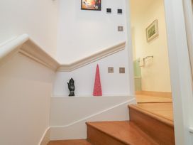 A staircase with a hand statue and a decorative cone at 8 Pottery Cottages