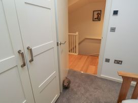 A hallway with doors and a staircase at 8 Pottery Cottages