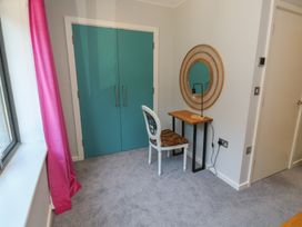 A bedroom with a desk and a chair at 8 Pottery Cottages