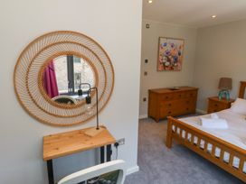 A bedroom with a bed and dresser at 8 Pottery Cottages