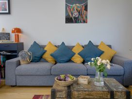 A living room with a sofa and coffee table at Mariners Retreat, 8 Pottery Cottages, Dartmouth