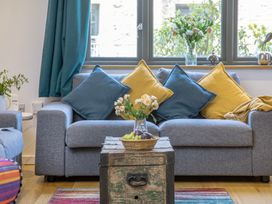 A living room with a couch and a coffee table at Mariners Retreat, 8 Pottery Cottages, Dartmouth