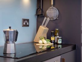 A kitchen with utensils and ingredients on a countertop at Mariners Retreat, 8 Pottery Cottages, Dartmouth