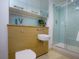 A bathroom with a sink and shower at Mariners Retreat, 8 Pottery Cottages in Dartmouth