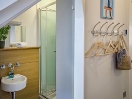 A bathroom with shower and hand basin at Mariners Retreat, 8 Pottery Cottages in Dartmouth