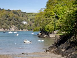 A scenic view of boats on water with trees and a house in the background at Mariners Retreat, 8 Pottery Cottages, Dartmouth