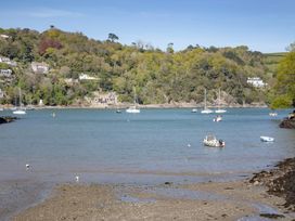 A view of boats on water with trees and houses in the background at Mariners Retreat, 8 Pottery Cottages, Dartmouth