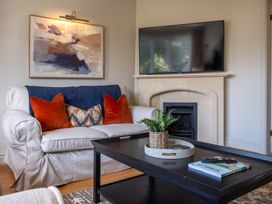 A living room with a sofa and television at Marina View, Bowness-On-Windermere