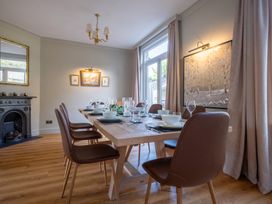A dining room with a table set for meals at Marina View in Bowness-On-Windermere