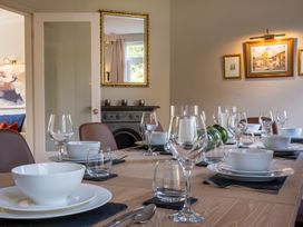 A dining room with a table set for dinner at Marina View in Bowness-On-Windermere