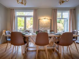 A dining room with a table and chairs at Marina View in Bowness-On-Windermere