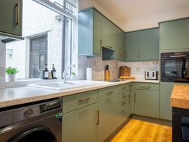 A kitchen with cabinets, sink, and appliances at Marina View in Bowness-On-Windermere