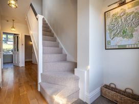 A hallway with a staircase and a map at Marina View in Bowness-On-Windermere