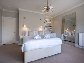 A bedroom with a bed and bedside table at Marina View in Bowness-On-Windermere