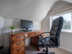 A home office with a desk and monitor at Marina View, Bowness-On-Windermere