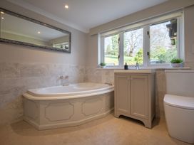 A bathroom with a bathtub, sink, and toilet at Marina View in Bowness-On-Windermere