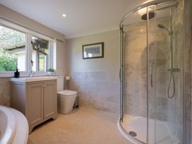 A bathroom with a shower and vanity at Marina View in Bowness-On-Windermere