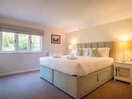 A bedroom with a large bed and window at Marina View in Bowness-On-Windermere