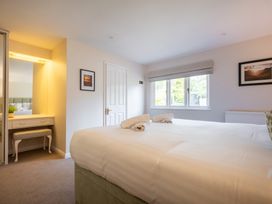A bedroom with a bed and a desk at Marina View in Bowness-On-Windermere