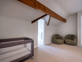 A playroom with a playpen and bean bags at Marina View in Bowness-On-Windermere