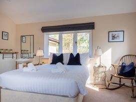 A bedroom with a bed and a mirror at Marina View in Bowness-On-Windermere