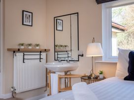 A bedroom with a sink and mirror at Marina View in Bowness-On-Windermere