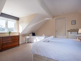 A bedroom with a window, dresser, and bed at Marina View in Bowness-On-Windermere