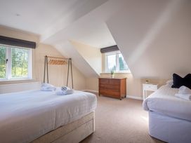 A bedroom with a bed and dresser at Marina View in Bowness-On-Windermere