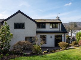 A house with windows and door in the garden at Marina View in Bowness-On-Windermere