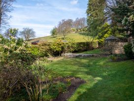 A garden with grass and shrubs at Marina View in Bowness-On-Windermere
