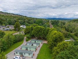 An aerial view of cabins with trees and train tracks at Lodge 4 Silverdale
