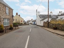 A street with stone and white houses and a stop sign at Hafod in Llanbedrog