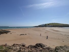 A beach with people walking and cliffs in the background at 6 Burgh Island Bigbury-On-Sea
