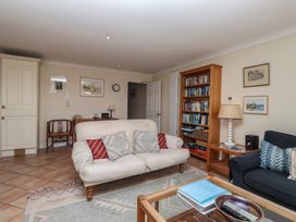 A living room with a sofa and bookshelf at 6 Burgh Island in Bigbury-On-Sea