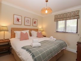 A bedroom with two beds and a bedside table at 6 Burgh Island in Bigbury-On-Sea
