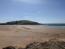 A beach with a view of a hill and buildings at 6 Burgh Island in Bigbury-On-Sea