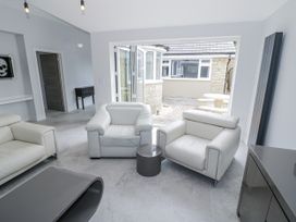A living room with armchairs and a coffee table at Chillon South Littleton near Honeybourne