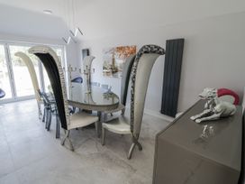 A dining room with a large table and unique chairs at Chillon South Littleton near Honeybourne