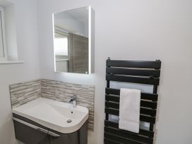 A bathroom with a sink and towel radiator at Chillon South Littleton near Honeybourne