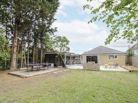 A garden with a table tennis table and a house at Chillon South Littleton near Honeybourne